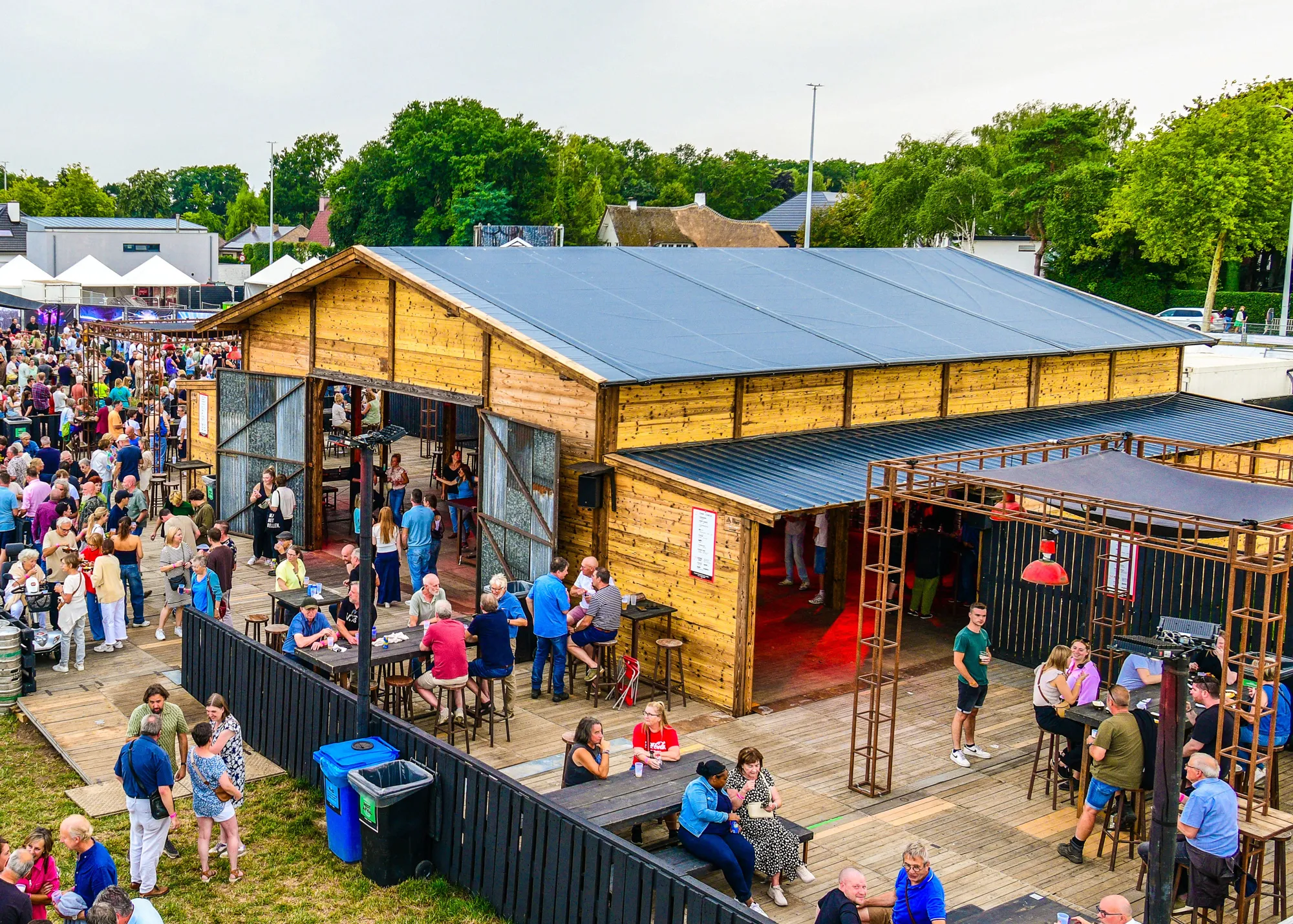 Interior view of a rustic event barn with timber beams and ambient lighting
