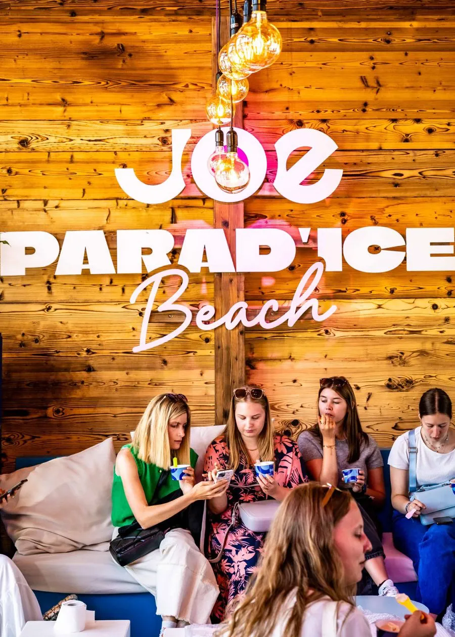 Warm festoon lighting hanging from the ceiling of a rustic event space