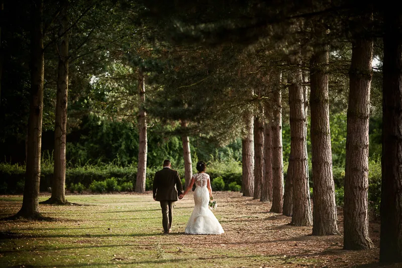 Outdoor wedding reception scene with rustic styling and woodland surroundings