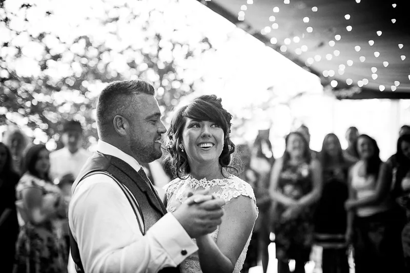 Celebration moment from Kate and Matt's rustic woodland wedding