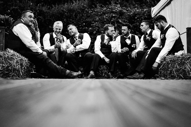 Bride and groom sharing a relaxed moment in the woodland setting after the celebrations