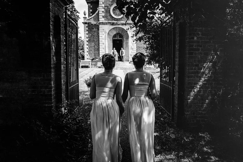 Wedding guests gathering in a woodland clearing for drinks and conversation
