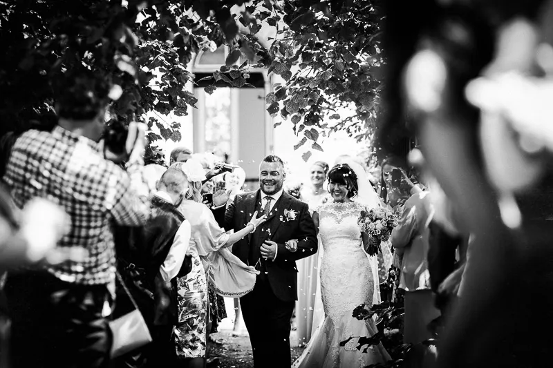 Guests relaxing on hay bale seating in a rustic themed wedding area